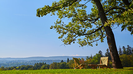 Image showing Relax with wooden chair and table. Enjoy the view of garden forest