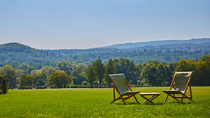 Image showing Relax with wooden chair and table. Enjoy the view of garden forest
