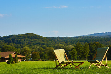 Image showing Relax with wooden chair and table. Enjoy the view of garden forest