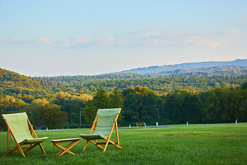 Image showing Relax with wooden chair and table. Enjoy the view of garden forest