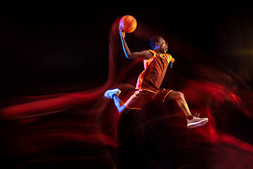 Image showing Young basketball player against dark background