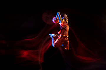 Image showing Young basketball player against dark background