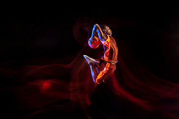 Image showing Young basketball player against dark background