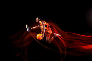 Image showing Young basketball player against dark background