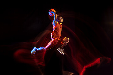 Image showing Young basketball player against dark background