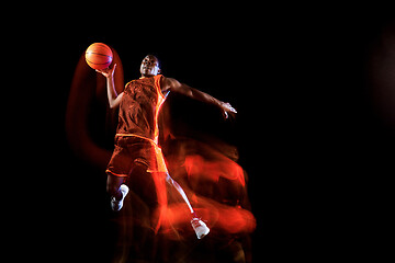 Image showing Young basketball player against dark background