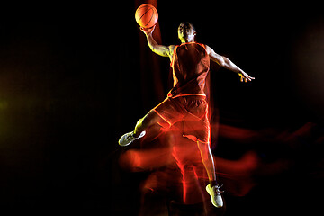 Image showing Young basketball player against dark background