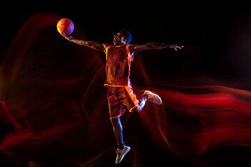 Image showing Young basketball player against dark background