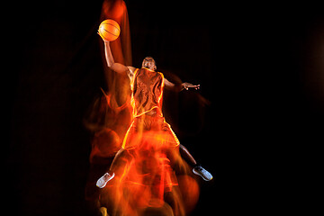 Image showing Young basketball player against dark background