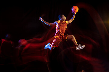 Image showing Young basketball player against dark background