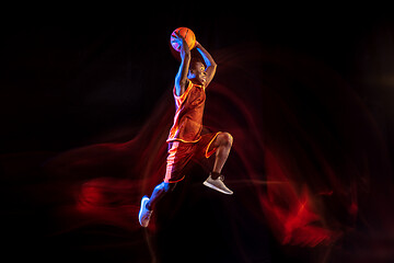 Image showing Young basketball player against dark background