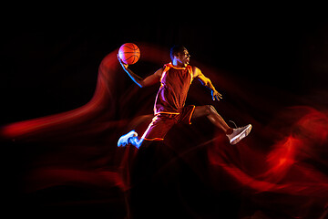 Image showing Young basketball player against dark background