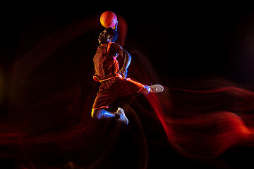 Image showing Young basketball player against dark background