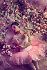 Image showing Young woman in pink ballet tutu surrounded by flowers