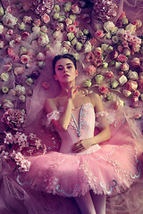 Image showing Young woman in pink ballet tutu surrounded by flowers