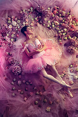 Image showing Young woman in pink ballet tutu surrounded by flowers