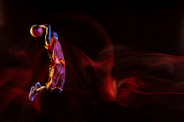 Image showing Young basketball player against dark background