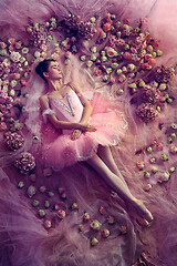 Image showing Young woman in pink ballet tutu surrounded by flowers