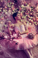 Image showing Young woman in pink ballet tutu surrounded by flowers