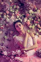 Image showing Young woman in pink ballet tutu surrounded by flowers