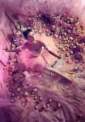 Image showing Young woman in pink ballet tutu surrounded by flowers