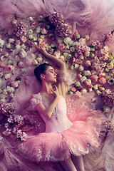 Image showing Young woman in pink ballet tutu surrounded by flowers