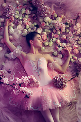 Image showing Young woman in pink ballet tutu surrounded by flowers