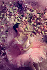 Image showing Young woman in pink ballet tutu surrounded by flowers