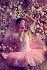 Image showing Young woman in pink ballet tutu surrounded by flowers