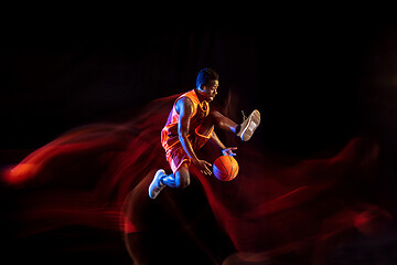 Image showing Young basketball player against dark background