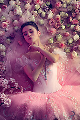 Image showing Young woman in pink ballet tutu surrounded by flowers