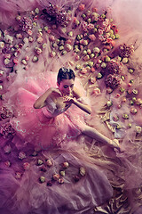 Image showing Young woman in pink ballet tutu surrounded by flowers