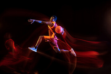 Image showing Young basketball player against dark background