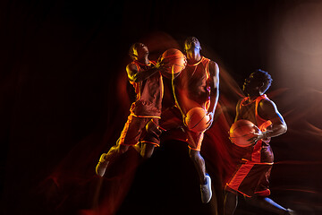 Image showing Young basketball player against dark background