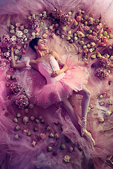 Image showing Young woman in pink ballet tutu surrounded by flowers