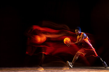 Image showing Young basketball player against dark background