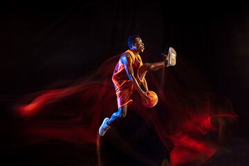 Image showing Young basketball player against dark background