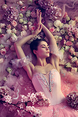 Image showing Young woman in pink ballet tutu surrounded by flowers