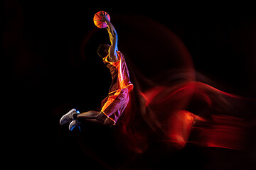 Image showing Young basketball player against dark background