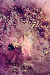 Image showing Young woman in pink ballet tutu surrounded by flowers