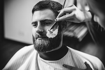 Image showing Client during beard shaving in barber shop