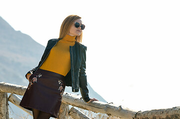 Image showing Girl tourist enjoying the view from the mountain