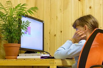 Image showing The girl thought while solving a problem in a computer as part of distance learning