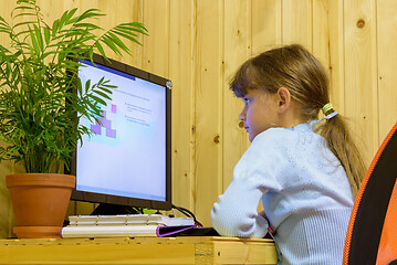 Image showing A girl solves a problem on a computer during distance learning