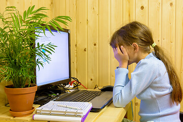 Image showing The girl closed her eyes from the fatigue of distance learning