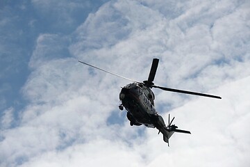 Image showing flying helicopter against the sky