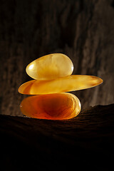 Image showing Beauty of natural amber. Three pieces of yellow natural amber on top of each other.