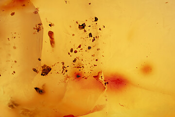 Image showing Natural amber texture. Yellow opaque natural amber with layers.