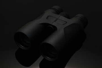 Image showing Hi tech black binocular on the black glass table.