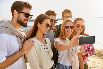 Image showing happy friends taking selfie on summer beach